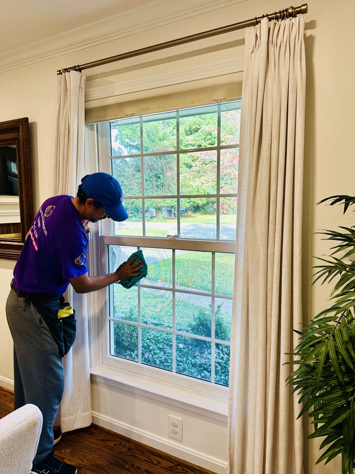 A Cleaning Cardinals team member cleaning an interior window